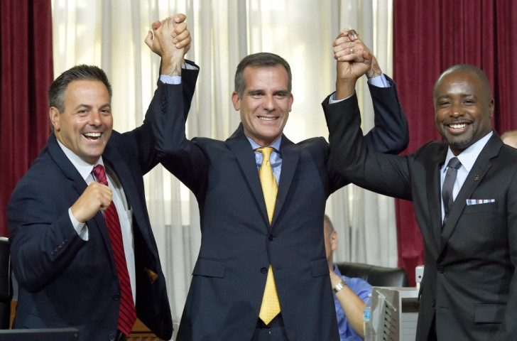 Los Angeles Mayor Eric Garcetti (centre) celebrates with Los Angeles City Councilmen Joe Buscaino (left) and Marqueece Harris-Dawson (right) after the Council voted to bid for the 2024 Olympic and Paralympic Games