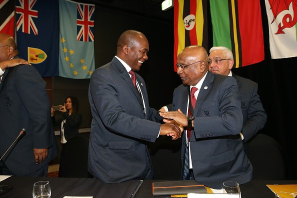 International Olympic Committee Sam Ramsamy (centre) celebrates after his home city Durban was awarded the 2022 Commonwealth Games, the first time the event will have been held in Africa 