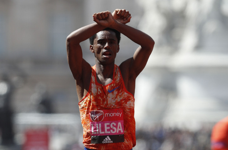 Ethiopia's Feyisa Lilesa, pictured making his familiar gesture of solidarity with his beleaguered Oromo people after running last year's London Marathon, will seek to regain the Tokyo title he won in 2016 ©Getty Images