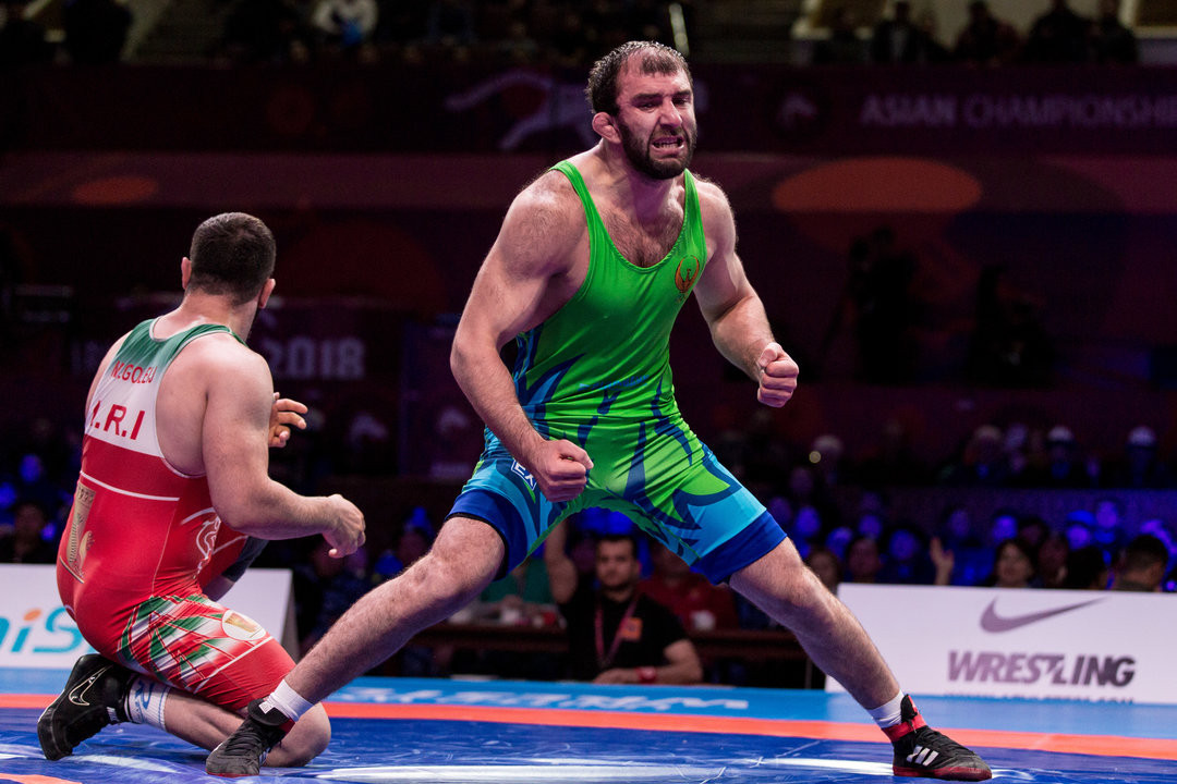 An exhausted Magomed Ibragimov of Uzbekistan acclaims victory at the Asian Wrestling Championships ©UWW