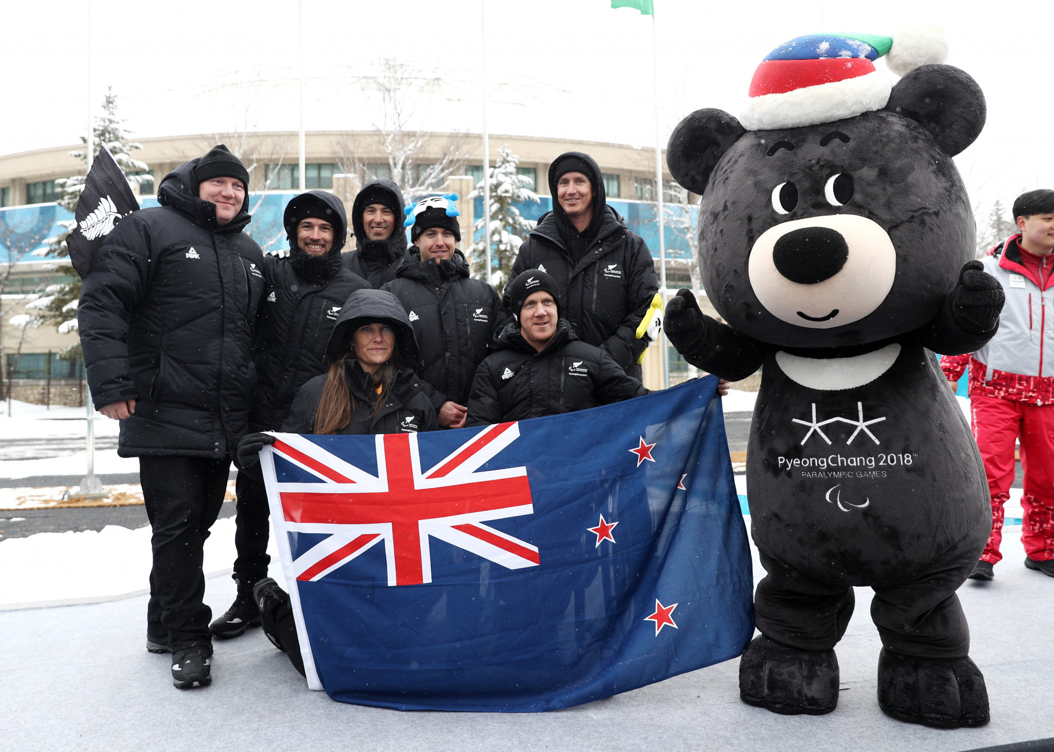 New Zealand athletes pose with Bandabi after being welcomed into the Athletes' Village ©Getty Images